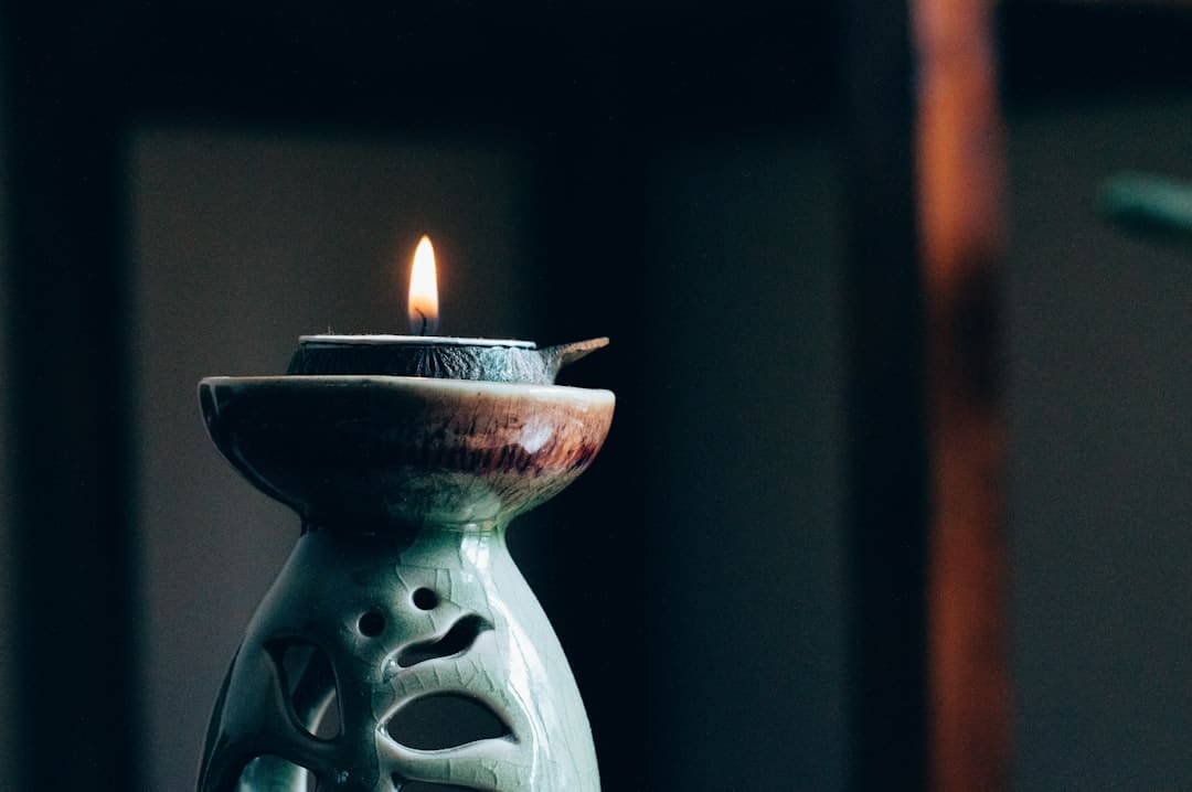 A propped up candle in a serene environment